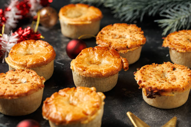 istock Christmas steak mini pie with decoration, gifts, green tree branch 2188984238