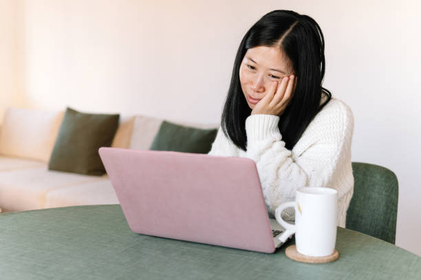 istock Asian woman tired while looking at laptop screen 2188984256