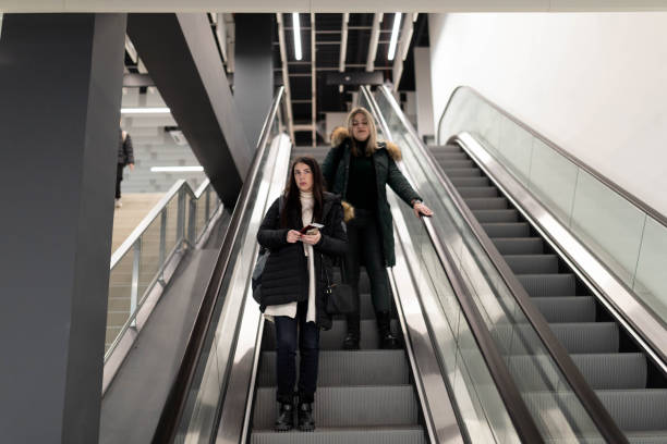 istock Women descend on the escalator. 2188985853
