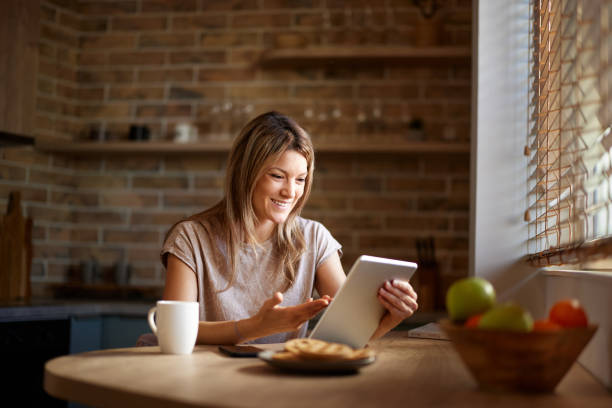 istock Happy woman having a video call over touchpad at home. 2188986344