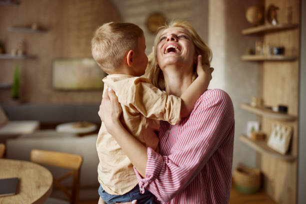 istock Cheerful mother having fun with her son at home. 2188986411
