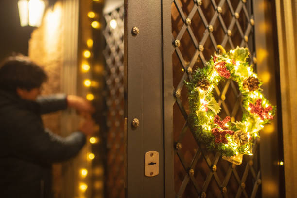 Man hanging Christmas decoration outdoors