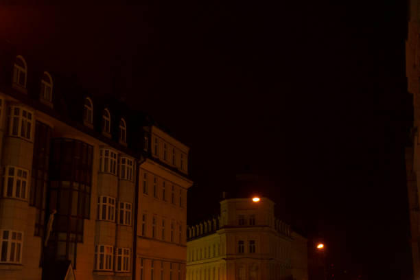 During the night, a beautiful row of buildings is brilliantly illuminated, showcasing their architecture against the dark sky