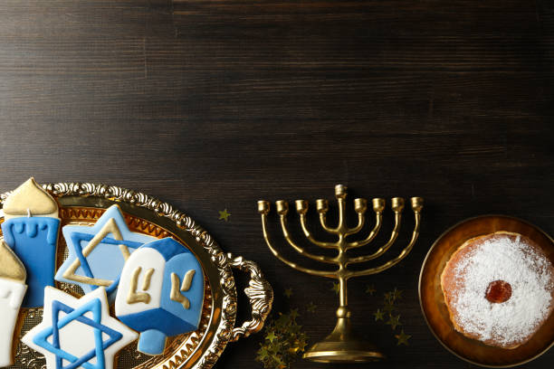 istock Gingerbread, Hanukkiah and donut on wooden background, space for text 2188990244