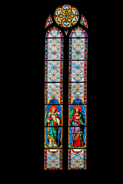 Paris, France: A stained glass window showing the crucifix inside the Church of Saint Jean de Montmartre, located in Montmartre. The window is art nouveau style.