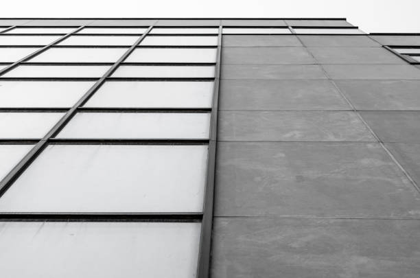 istock empty windows of a gray high concrete building close up 2188990527
