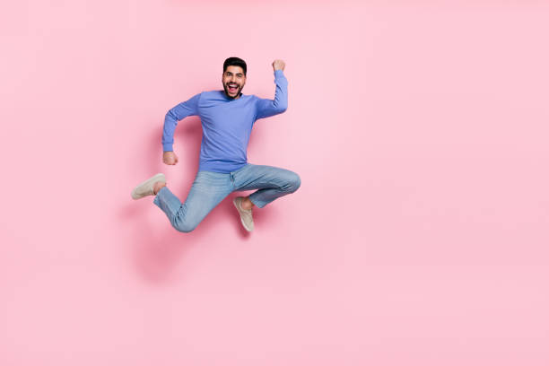 istock Full length photo of lucky funky guy dressed blue pullover jumping high empty space isolated pink color background 2188990544