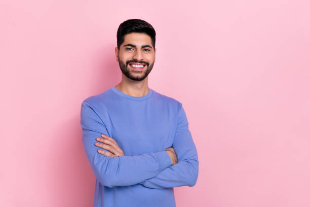 istock Photo of confident attractive arab guy dressed blue pullover arms crossed empty space isolated pink color background 2188990733