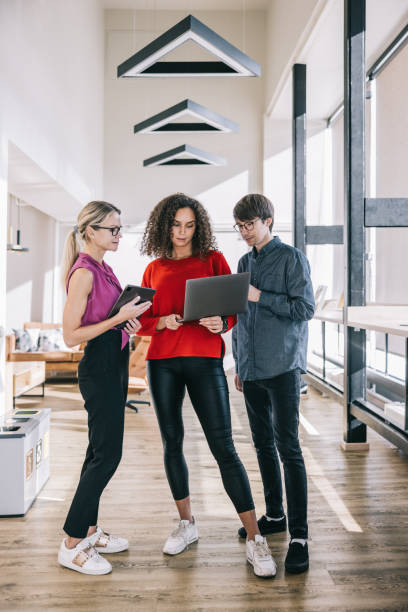 istock Three business professionals engage in a brief office meeting 2188991563