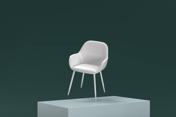istock A white chair is sitting on a green surface 2188992849