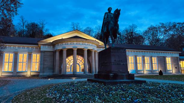 Stuttgart, Germany - 11/27/2024, Kurhaus entrance at night. The monument to King Wilhelm I of Württemberg in front was unveiled in 1875.