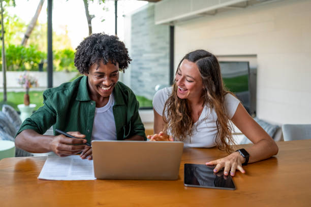istock Happy Couple Working Together on Laptop at Home Desk 2188995021