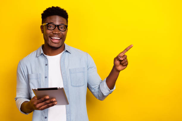 istock Photo of positive excited guy using device app demonstrate electronics discounts isolated vivid color background 2188995215