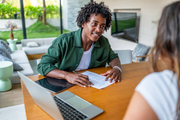 istock Young Professional Discussing Business with Client in Modern Office Setting 2188995881
