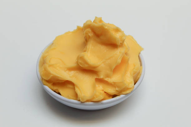 Bakery margarine in a small white bowl, isolated on white background. Spread for bakery purpose.