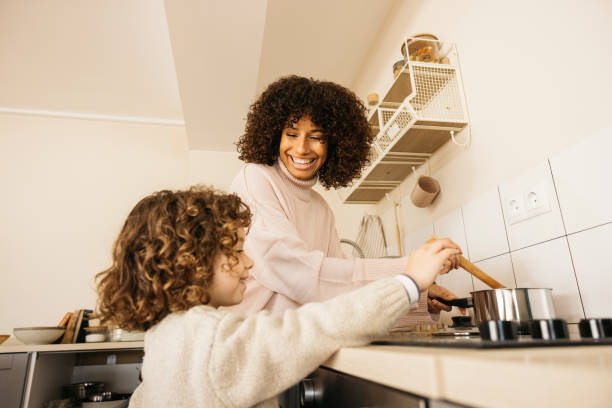 istock Mother and child enjoying a cooking lesson together in a bright kitchen. 2189000242