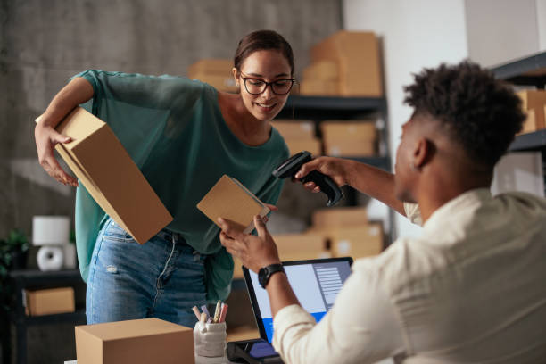istock Woman scanning box with coworker 2189003667