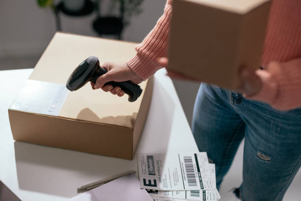 istock Close-up of hands scanning barcode on package 2189003689
