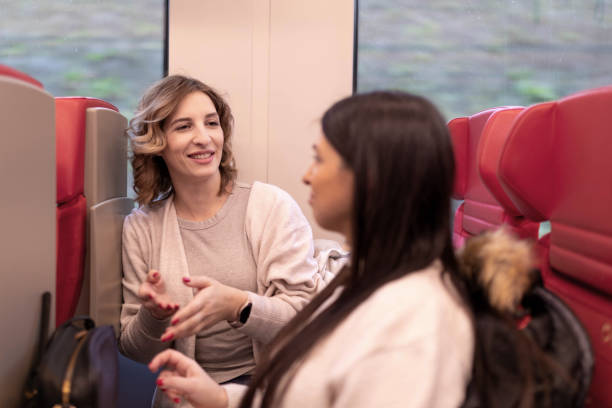istock Two friends are traveling on the subway and talking. 2189004548