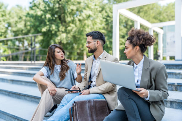 istock Group of modern successful business people innovative technology experts standing out of office building, discussing ideas and innovations. Leaders in global marketing strategy professional occupation 2189007779