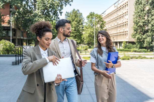 istock Group of modern successful business people innovative technology experts standing out of office building, discussing ideas and innovations. Leaders in global marketing strategy professional occupation 2189007815