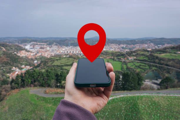 istock hand holding a smart phone searching location, with a gps symbol 2189009018