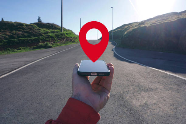 istock hand holding a smart phone searching location, with a gps symbol 2189009019