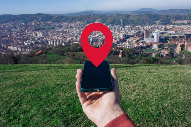 istock hand holding a smart phone searching location, with a gps symbol 2189009022