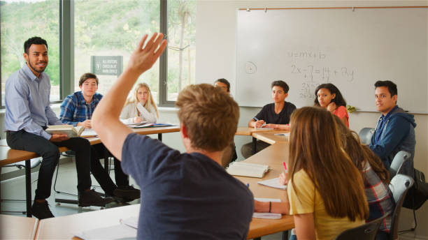 istock Male Student Asking Tutor Question Tutor In High School College Or University Students Maths Class 2189009226