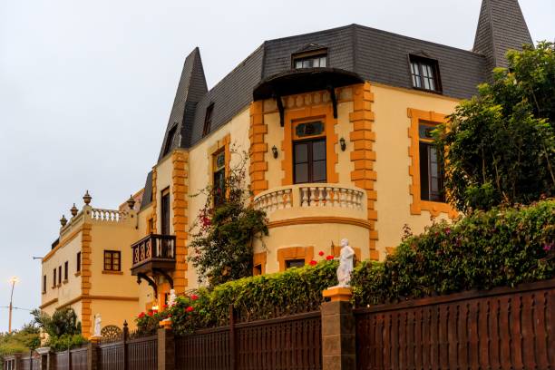 Lima, Peru – September 23, 2019: Elegant historic mansion with ornate architecture and lush greenery, captured on a cloudy day in Callao District