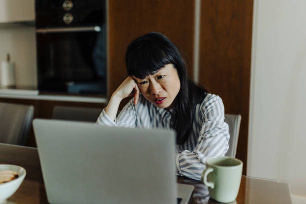istock Tired businesswoman working on laptop 2189011225