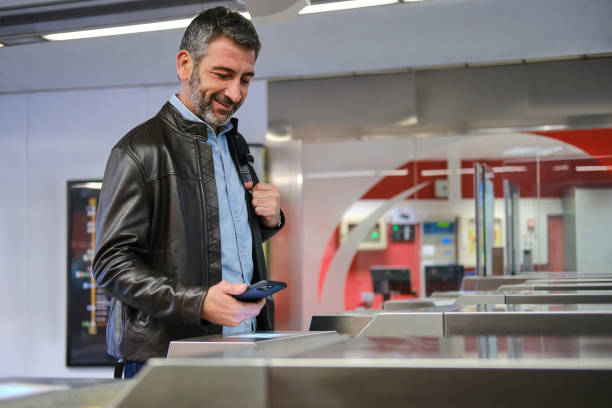istock Tourist validating electronic ticket with his smartphone at subway station in barcelona 2189011626