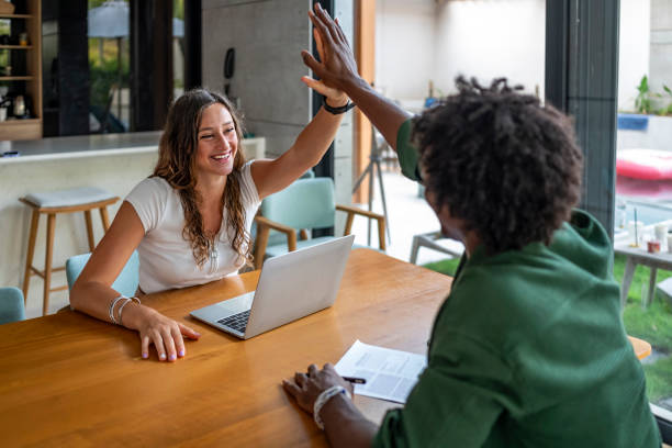 istock Two Colleagues Celebrating Success With a High Five at the Office 2189011746