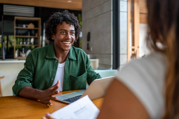 istock Young Man Engaged in a Positive Conversation at a Coffee Shop 2189011754