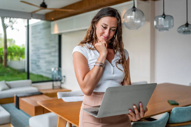 istock Professional Woman Working on Laptop in Modern Home Office Setting 2189011798