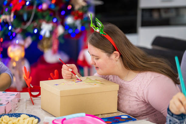istock Girl with Down's syndrome drawing on Christmas 2189012075