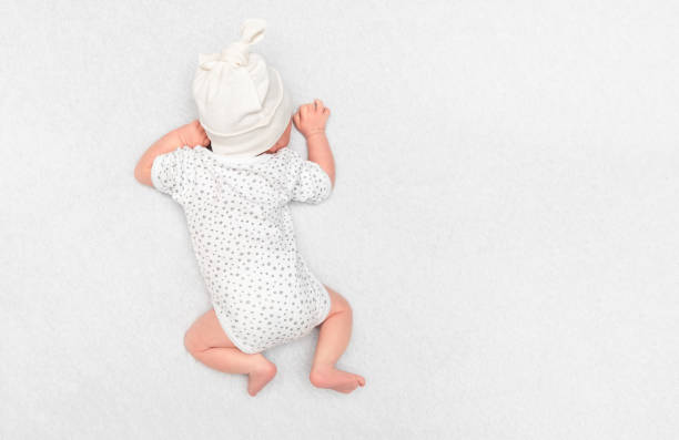 istock baby lying on stomach, top view 2189012387