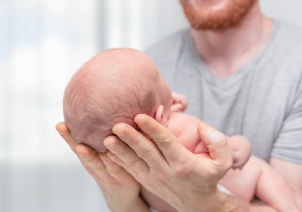 Closeup color photo of a beautiful newborn baby sleeping peacefully.
