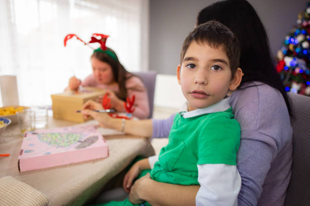 istock Mesmerized boy with autism crafting with his mom 2189013381