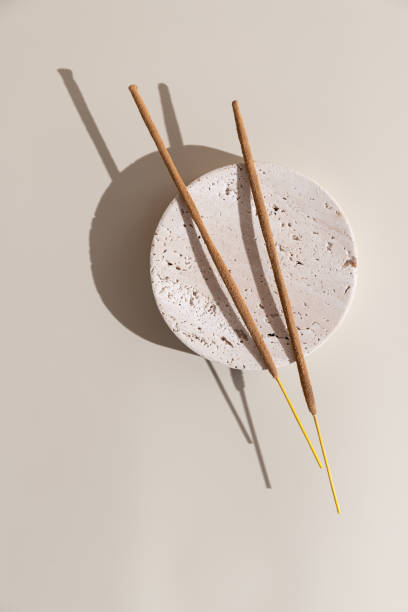 istock Incense sticks on a round stand on a beige background, top view, still life 2189013583