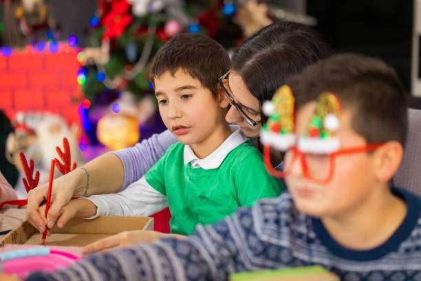 istock Mesmerized boy with autism crafting with his mom 2189014012