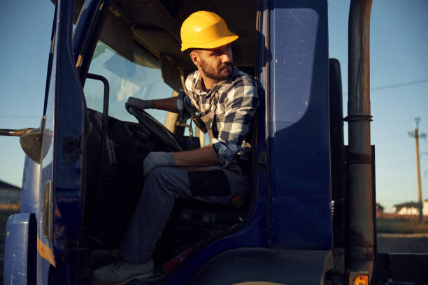 istock Construction worker is sitting in the truck cabin 2189015404