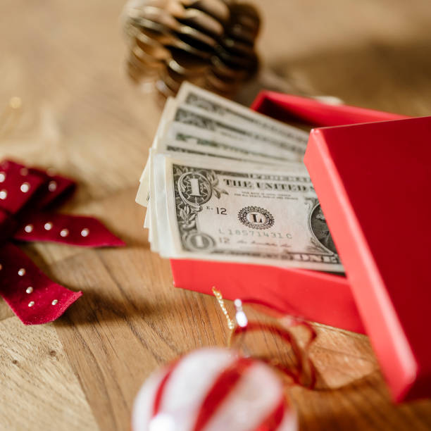 istock Christmas present money dollar bills in a gift box 2189015553