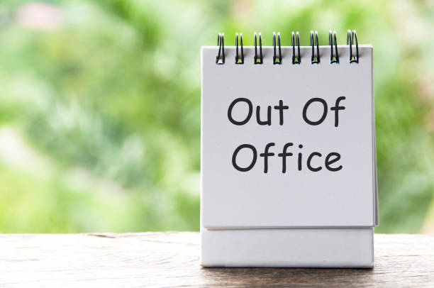 istock Out Of Office text on white notepad with blurred nature background 2189015852