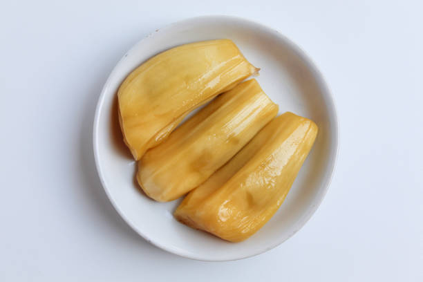 A green jackfruit with white background.