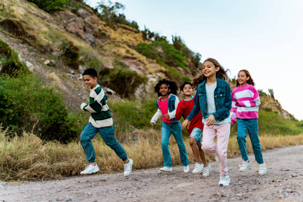 Child friends running during summer camp outdoors