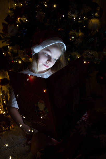 istock little girl in christmas tree 2189017855