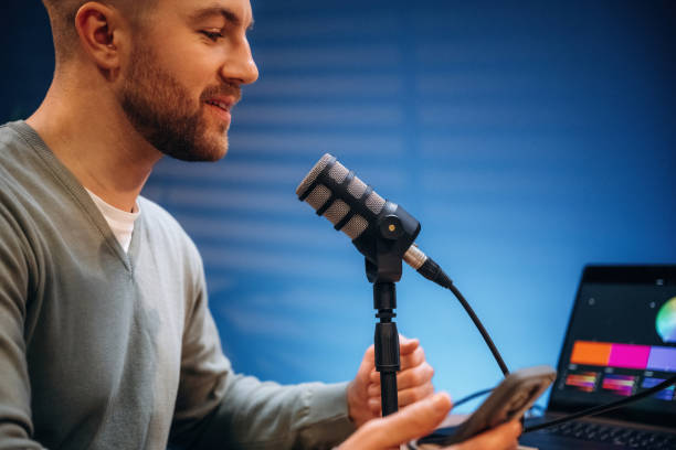 istock Man with microphone in the studio, conception of podcast 2189018426