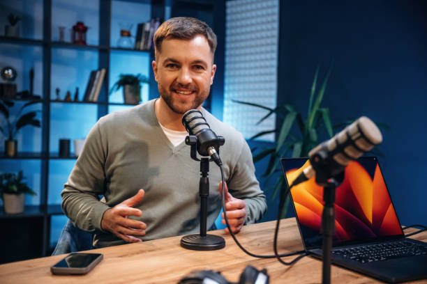 istock Man with microphone in the studio, conception of podcast 2189018451