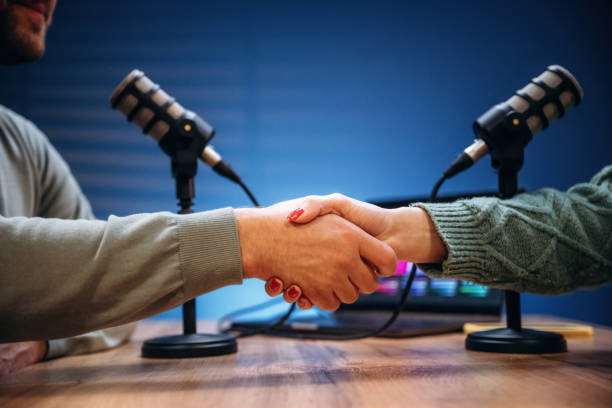 istock Making handshake. Radio hosts recording podcast 2189018495